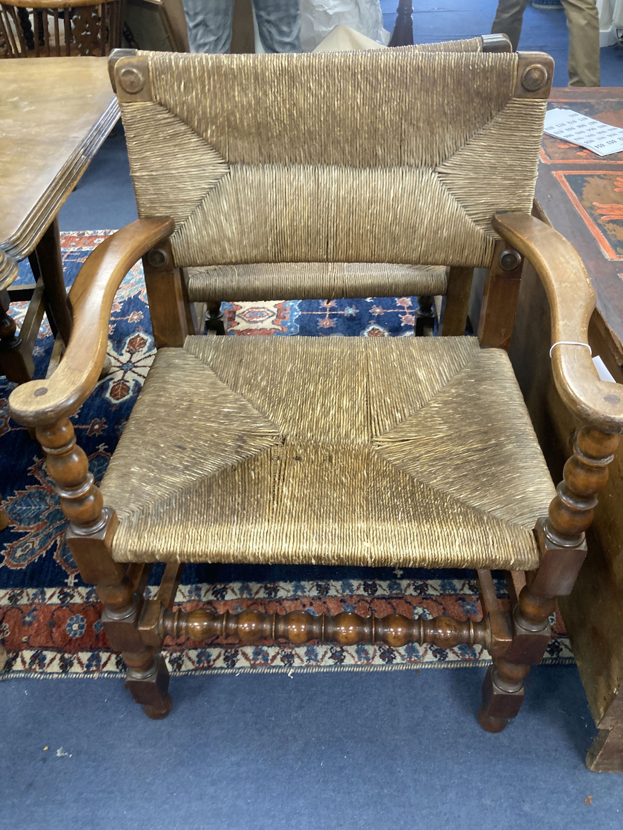 A set of eight turned beech dining chairs with rush seats and backs (two with arms)